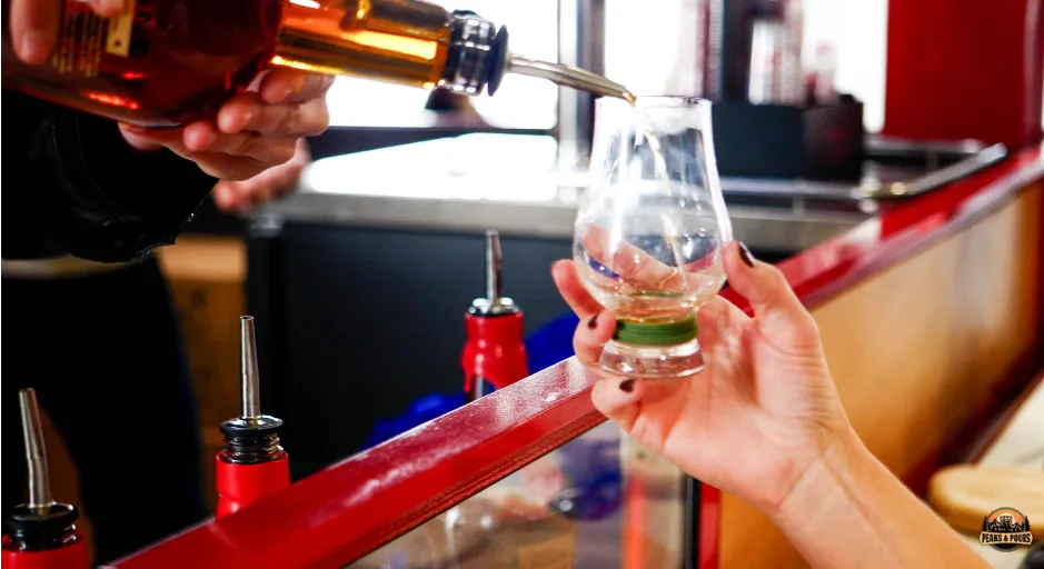 Pouring Maker's Mark at the Maker's Mark booth at Peaks and Pours 2023